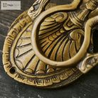 Victorian cast brass owl door knocker close-up of circular ring handle and ornate base