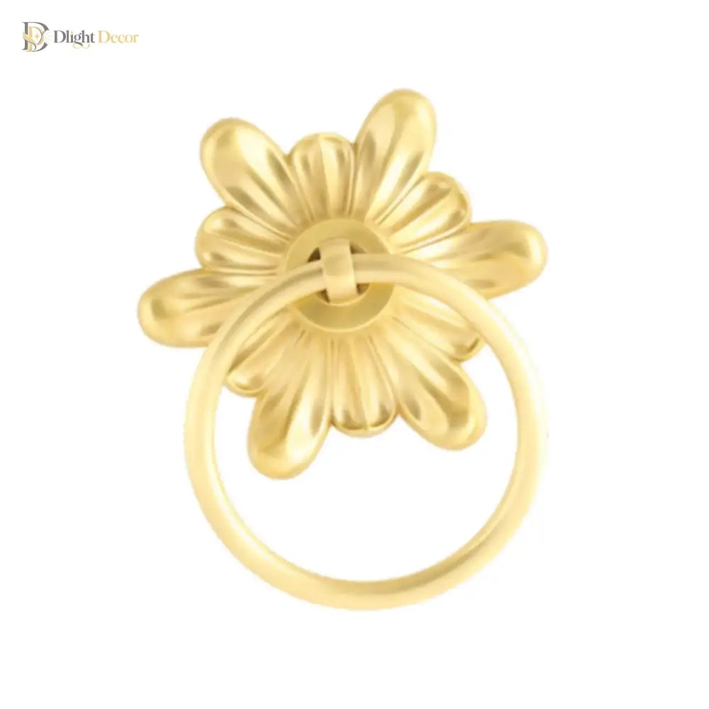 Gold-tone floral ring pull door knocker, close-up with round hoop ring