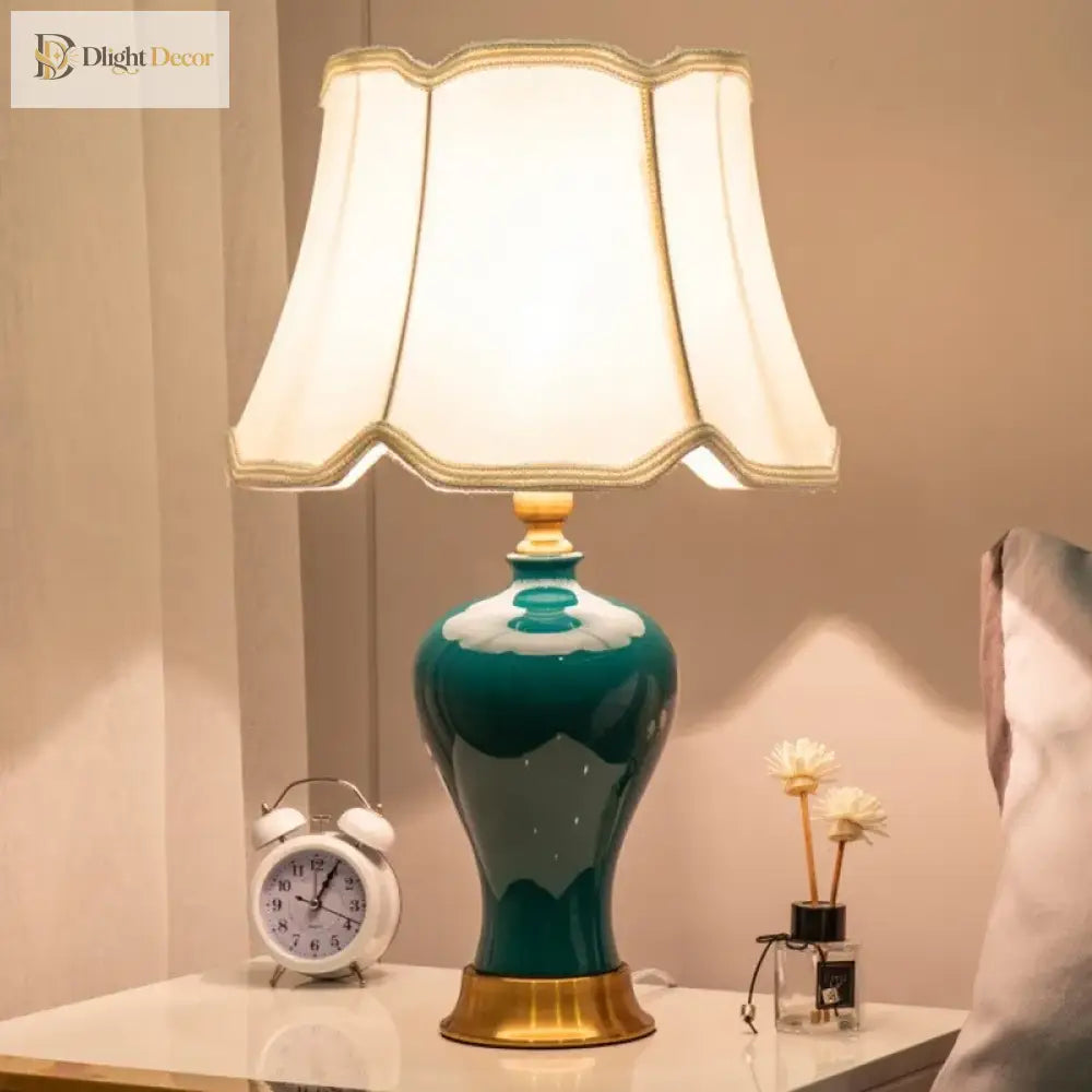 Teal ceramic LED desk lamp with illuminated pleated shade and gold edging