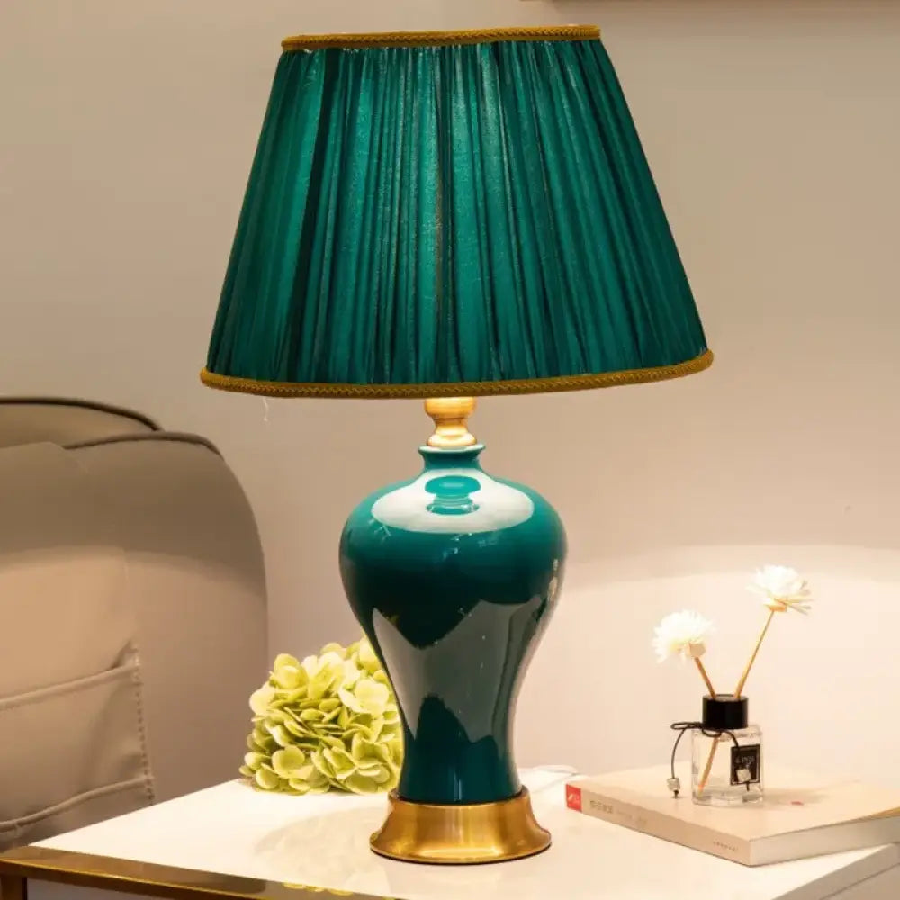 Teal ceramic LED desk lamp with pleated teal drum shade and gold trim