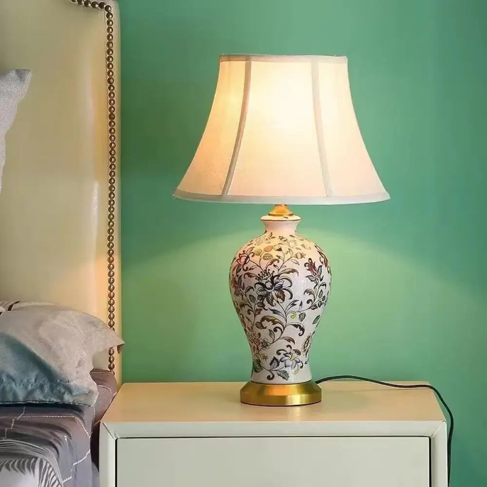 Floral ceramic table lamp with pleated shade and black power cord