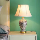Floral ceramic table lamp with pleated shade and black power cord
