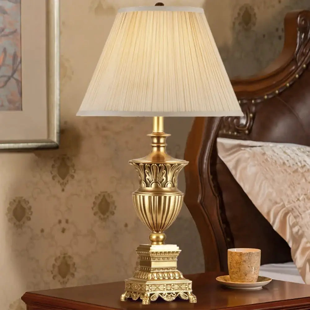LED desk lamp with beige pleated shade and ornate gold base