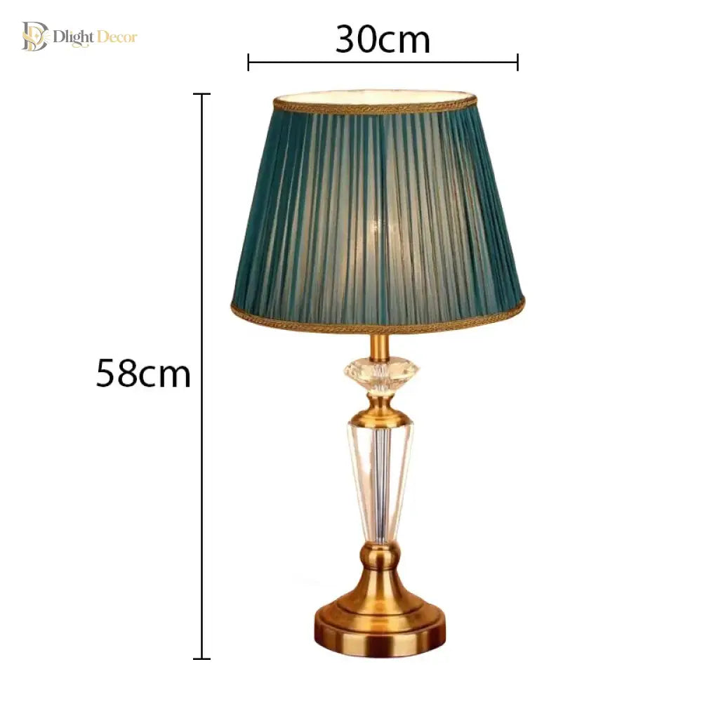 Teal pleated fabric LED table lamp with gold stand and clear crystal column base