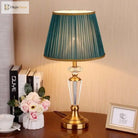 Gold and clear crystal LED table lamp with pleated teal fabric shade and pedestal base