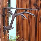 Retro iron triangle shelf bracket, dark metal finish, wall-mounted with star arms