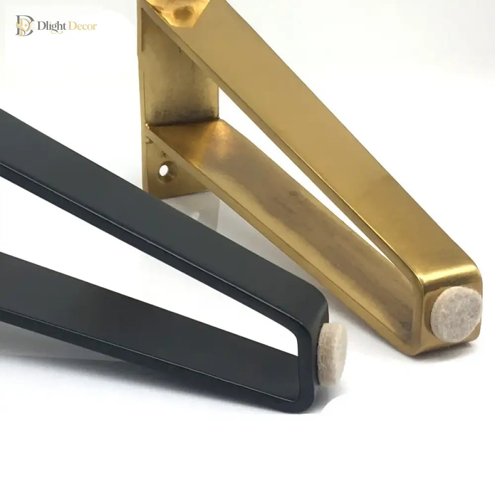 Detail view of U-shaped metal furniture leg bases with end caps, gold and black