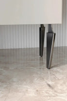 Black half-curved adjustable furniture legs, set of 4, supporting a cabinet corner