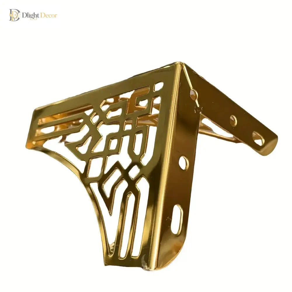 Gold-tone metal corner furniture leg with geometric cutouts and oval mounting holes