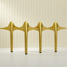 Four gold stainless steel furniture legs with rubber protectors, tapered spade-style bases