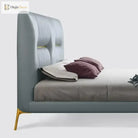 Gold stainless steel furniture leg with rubber protector on upholstered bed frame