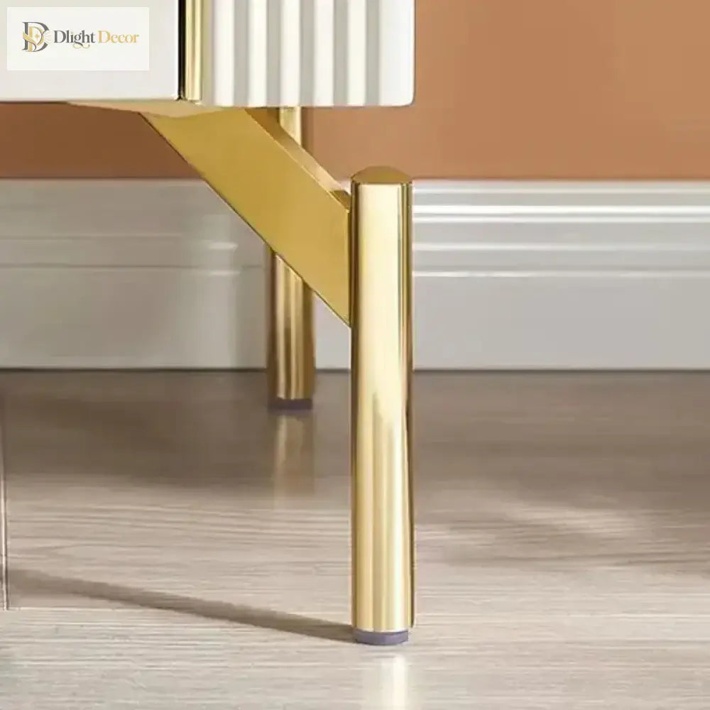 Gold stainless steel furniture leg supporting a cabinet corner
