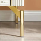 Gold stainless steel furniture leg supporting a cabinet corner