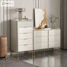 Gold stainless steel legs under a white cabinet dresser