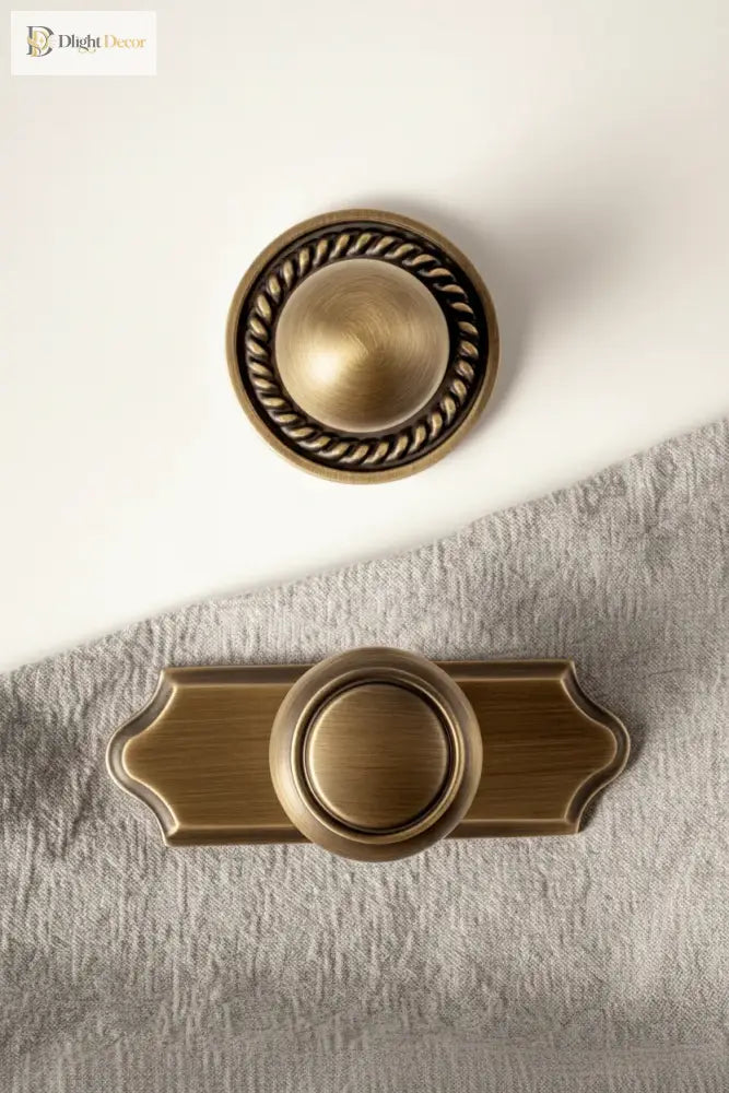 Solid brass single-hole cabinet handle with round knob and scalloped backplate, antique finish