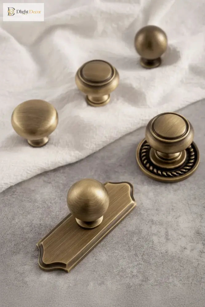 Set of single-hole cabinet handles with round knobs and decorative circular backplates, solid brass