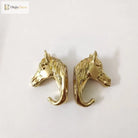 Solid brass horse head cabinet knob pair, angled view on white background