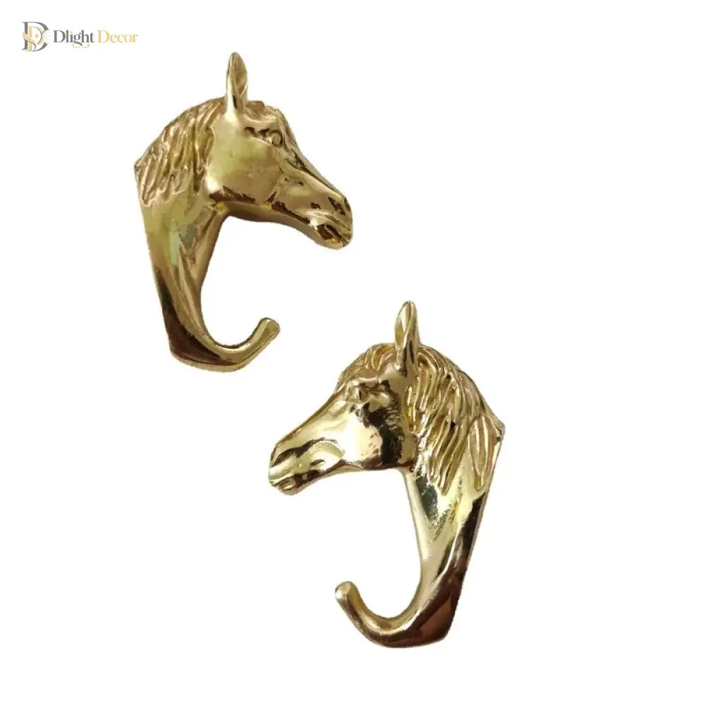 Solid brass horse head cabinet knob pair, facing different directions with hook backs