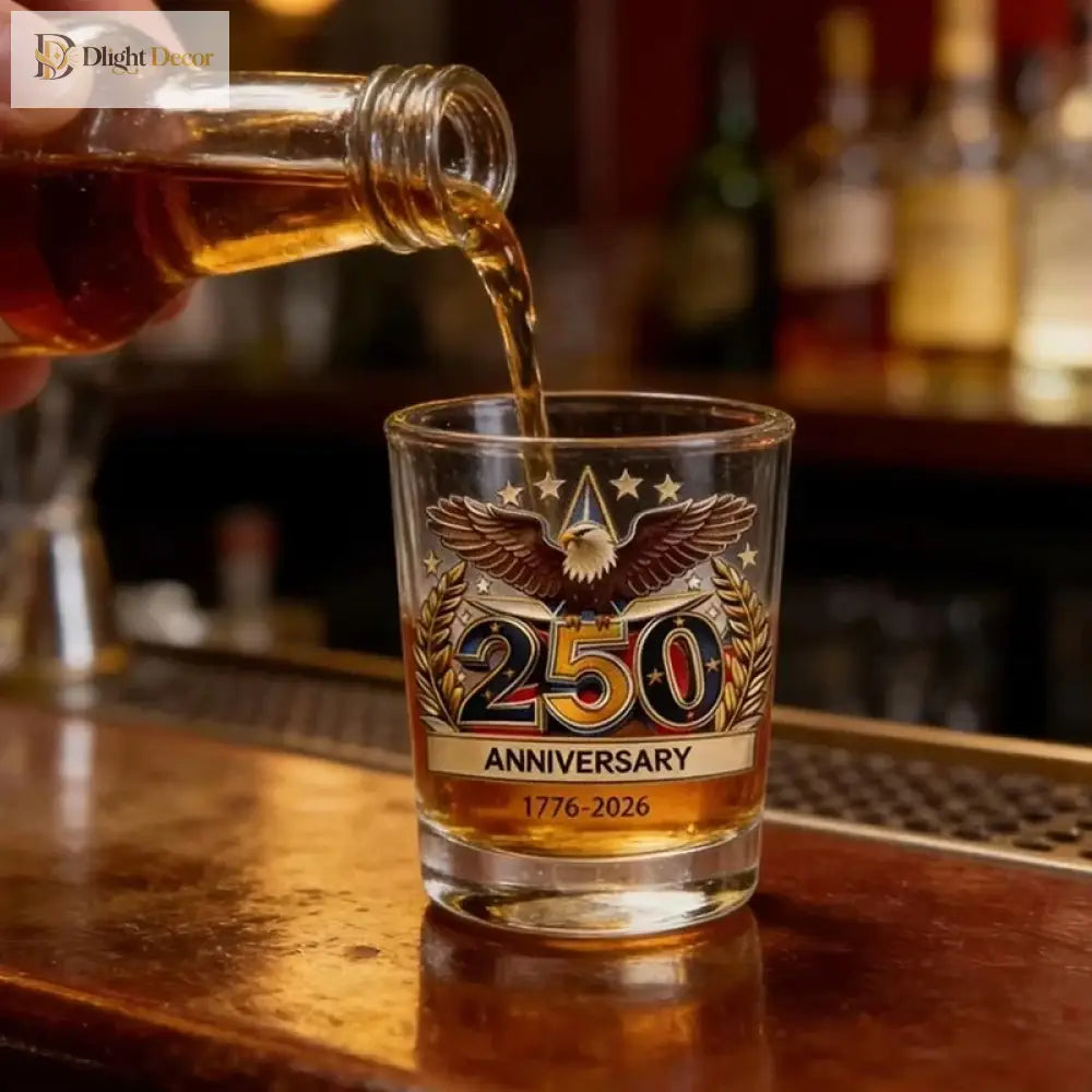Whiskey tumbler with '250 Anniversary' emblem and golden American eagle, filled with amber drink