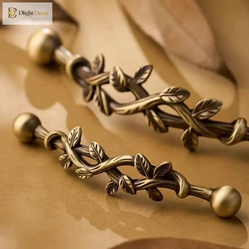 Antique bronze vine drawer pull handle with two ball ends and raised leaf pattern