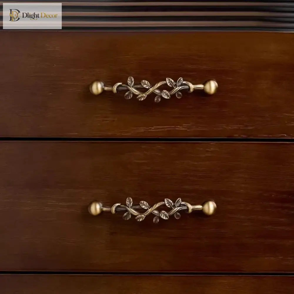 Set of antique bronze vine drawer pulls with two round knobs and leaf scroll detail