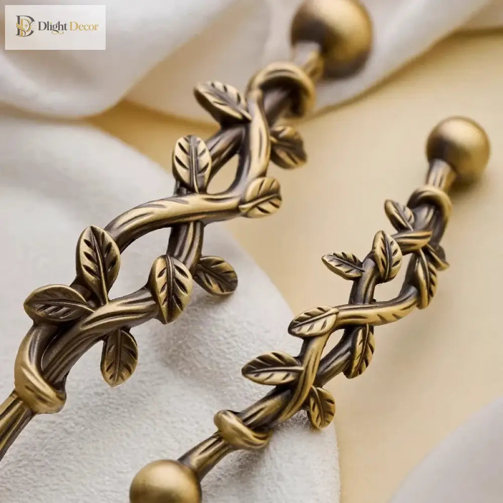 Close-up antique bronze vine cabinet pull handle with leaf motif and two ball ends