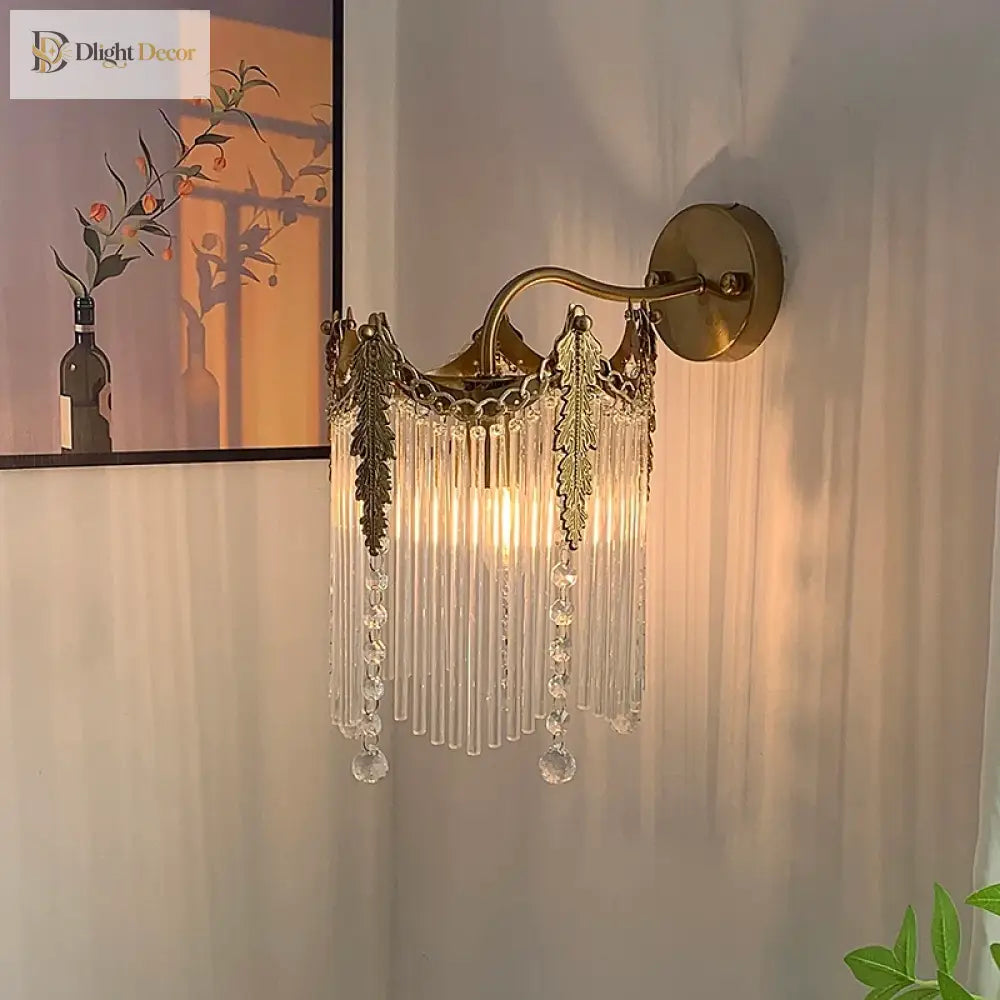 Gold crystal wall sconce with crystal fringe and round backplate, wall mounted