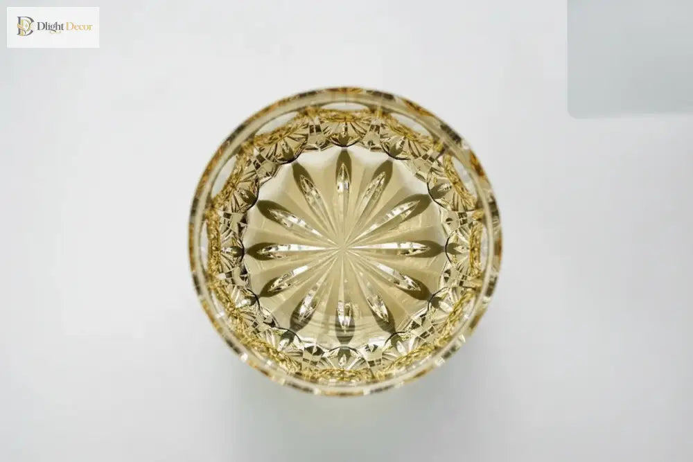 Amber crystal whiskey tumbler top view with circular starburst pattern