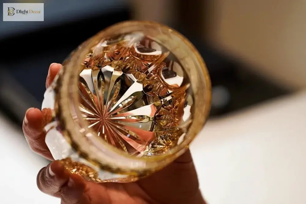 Amber cut crystal whiskey tumbler bottom view with starburst and etched details