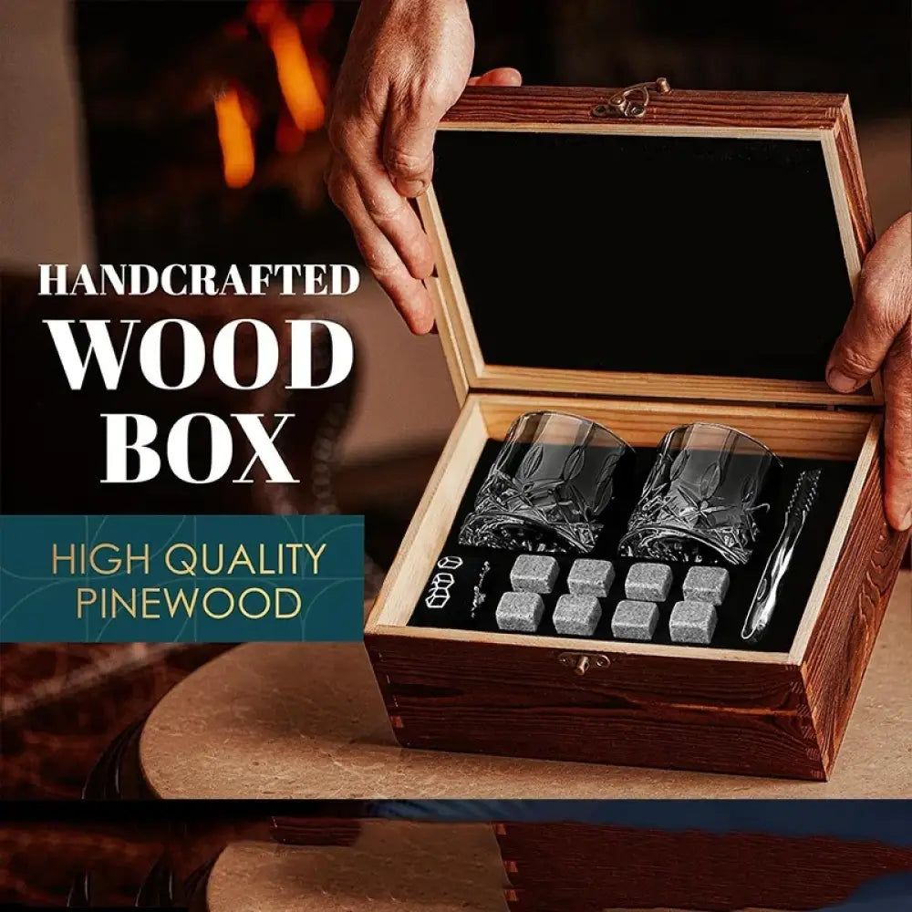 Whiskey glass gift set in open pinewood box with two tumblers, stones, and metal tongs