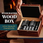 Whiskey glass gift set in open pinewood box with two tumblers, stones, and metal tongs