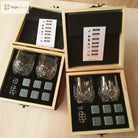 Whiskey rocks and two faceted tumblers in a divided wooden box