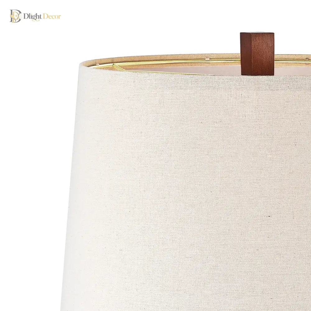 Beige fabric lampshade with dark wood finial and inner socket detail